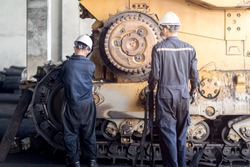 Heavy machinery maintenance and repair, Mechanic man assembly track link of the bulldozer in coal power plant