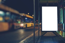 Illuminated blank billboard with copy space for your text message or content, advertising mock up banner of bus station, public information board in night city, auto bus stop empty poster