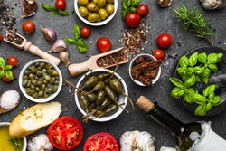 Mediterranean diet background. Cooking ingredients on dark slate.