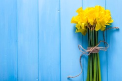 Spring easter background with daffodils bouquet on wooden table