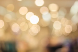 abstract blurred bokeh light in department store with warm tone color background concept.
