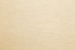 Abstract flat bright cream tan colored fabric textile texture background.