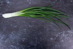 
fresh green onions on a dark background. healthy eating concept vegetarian food