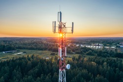 Mobile communication tower during sunset from above. (high ISO image)