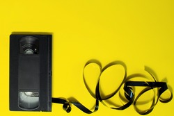 Cassette for a VCR  video recorder on a yellow background.