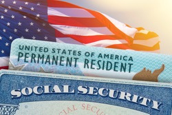 Green Card US Permanent resident USA and Social Security card. Electronic Diversity Visa Lottery DV-2022 DV Lottery Results. United States of America. American flag on background.
