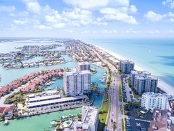 Island in Gulf of Mexico. Ocean or shore. Spring break or Summer vacations in Florida. Hotels, restaurants and Resorts. Tropical Nature. Clearwater Beach FL. Aerial view.