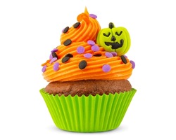 Cupcake on Halloween. Pumpkin Jack o lantern. Dessert on Halloween party. Muffin decorated with colored sprinkles, frosting and Icing shaped pumpkin Jack-o-lantern. Cupcakes. White isolated background