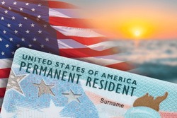 Green Card. US Permanent resident card. Immigration to USA. Electronic Diversity Visa Lottery DV-2024 DV Lottery Results. United States of America. American dream. Sunset, American flag on background