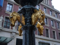 Four golden horse heads as an ornament on an old lantern in Bremen