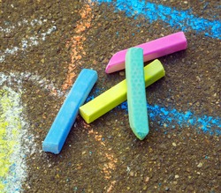 Colored chalk for drawing. Colored chalk on the playground with drawings on the street