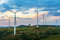 Evening view of wind turbines or windmills farm field and mountain hill in Phetchabun, Thailand.