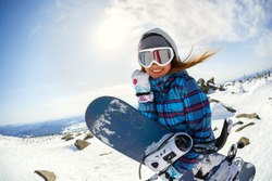 Girl snowboarder enjoys the ski resort. Sheregesh. Russia.