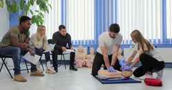 Male instructor teaching first Aid Cpr technique to his students.
