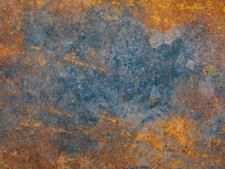 Corrosion. Metal plate with weathered colors and rust. Natural light. Blue and orange metal plate. Old oxidized colorful textured surface. Abstract grunge rusty metallic background for multiple uses.