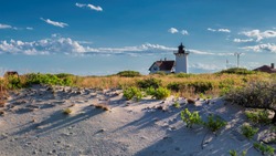 Lighthouse Point on beach dunes. Race Point Light Lighthouse in Cape Cod, New England, Massachusetts, USA.