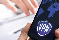 Person uses VPN technology on mobile phone. Anonymous and secure internet access concept background