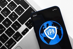 VPN, anonymous, safe and secure internet access on mobile phone. Desktop with laptop, technology background