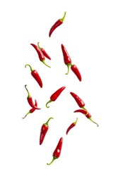 Fresh red chilli peppers floating in the air. food levitation. Falling red chilli peppers isolated