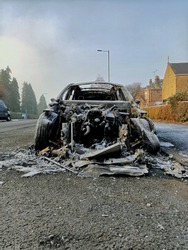 Ruins of a burned car in frost