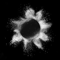 White and black composition from round frame and powder explosion on a black background, copy space.