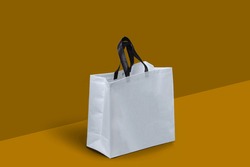 White Fabric Non Woven Box Bag Mockup on dark yellow background. Copy Space for Text and Logo. Eco Friendly Concept. white shopping grocery shopper isolated yellow background. empty kraft bag