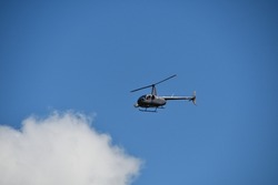 A light helicopter with a bow-mounted thermal imaging camera used to inspect high-voltage overhead power lines