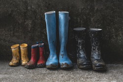 four pairs of muddy rain boots