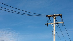 Electric Pole Power Lines And Wires With Blue Sky Background
