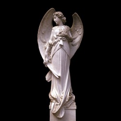 Medieval angel statue isolated on black background.
