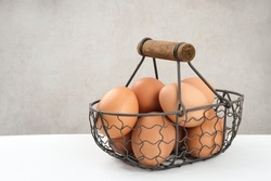Raw organic farm eggs.Served in iron basket with copy space. Selective focus image.
