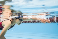 Woman swimming pool . Underwater photo
