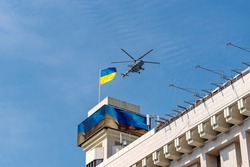 KYIV, KIEV, UKRAINE - August 24, 2021: Military aviation concept. Air Force of Ukraine. A Ukrainian MI-8 helicopter flies over the flag of Ukraine on the 30th Independence Day at a military parade.