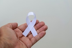 White January, mental health awareness campaign. hand with white ribbon. 