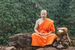 Monk meditating on top of a mountain,Purify the mind, Religious concept.
