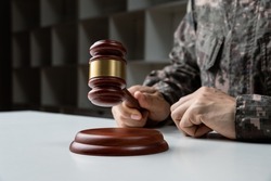 Military Law concept, Hand of soldier holding gavel