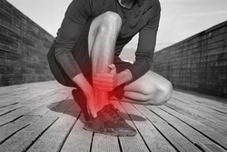 Fitness runner with ankle pain or achilles injury. Ankle twist sprain accident. Running or workout injury