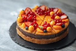 Closeup on decorated sweet orange berry and fruit cake