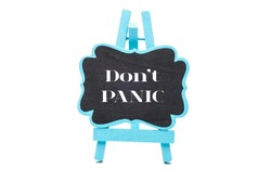 Chalkboard in blue wooden frame isolated on white background with don't panic words