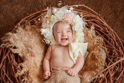 Adorable beautiful newborn baby girl. Maternity and newborn concept. Newborn baby on beautiful background is looking in the camera