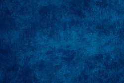 Uneven old rough dark blue texture background with scratches