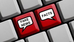 Red Computer Keyboard with balloons showing Fake News or Facts