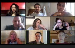 Shot of a screen of teammates doing a virtual happy hour from their home offices.  Team meeting from home during COVID-19 coronavirus pandemic.