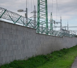 Barbed wire fence , restricted area. Protection for Electrical power transformers in high voltage substation.