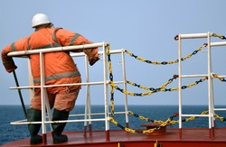Crew member dummy staying on the forecastle of the vessel in Nigerian waters. Anti piracy measures.