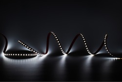 LED strip with white lighting on a dark decorative background