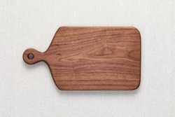 Handmade walnut chopping board on burlap