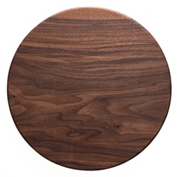 Handmade black walnut round wood plate. Walnut round wooden tray. Black walnut wood plank texture background.