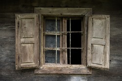 Croatia, May 01,2022 : Rustic style aged window at rural home wall.