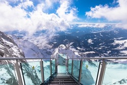Spectacular alpine view with the Stairscase to Nowhere on the snowy Dachstein summit, Schladming, Styria, Austria. Pure thrill combined with a magnificent view.
